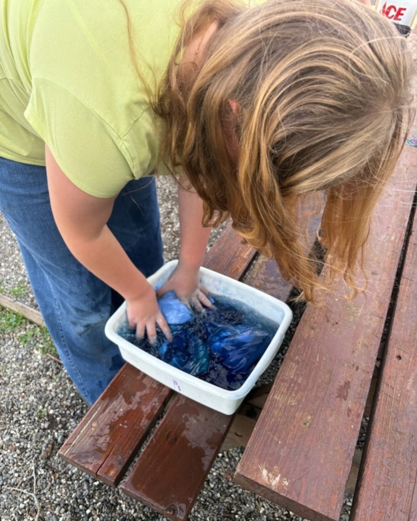 Pictured here, is one of Jessica's students doing one final rinse!