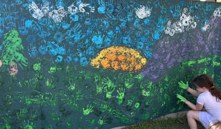 A picture of our new mural that every single student helped to create!