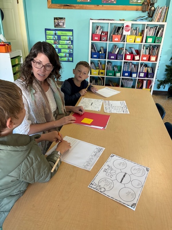 Kristina working on reading and writing skills with two students!