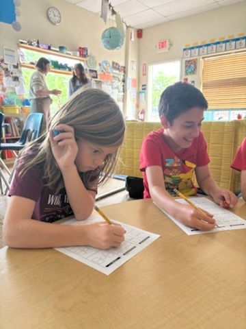 Here we have two students collaborating together on their fractions worksheet!