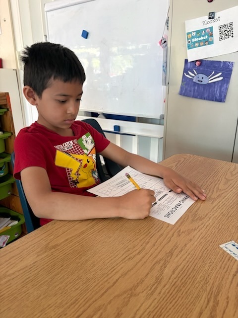 Here is one of our students completing a fractions worksheet!