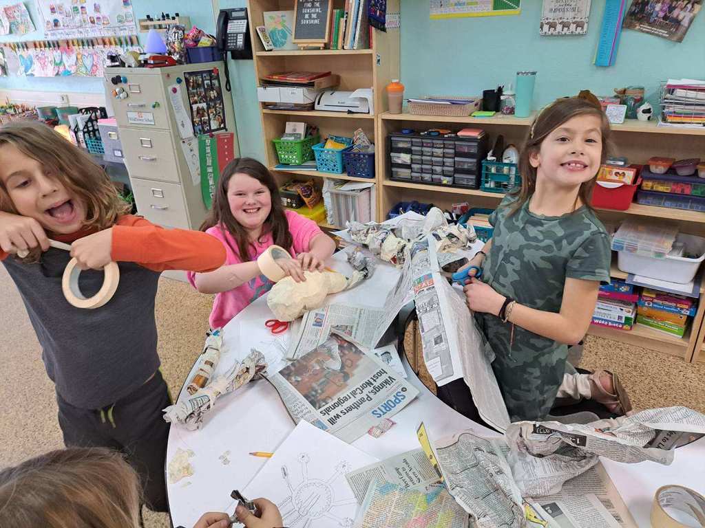 A group of students having some fun and putting the joy into puppet making along with their hard work!