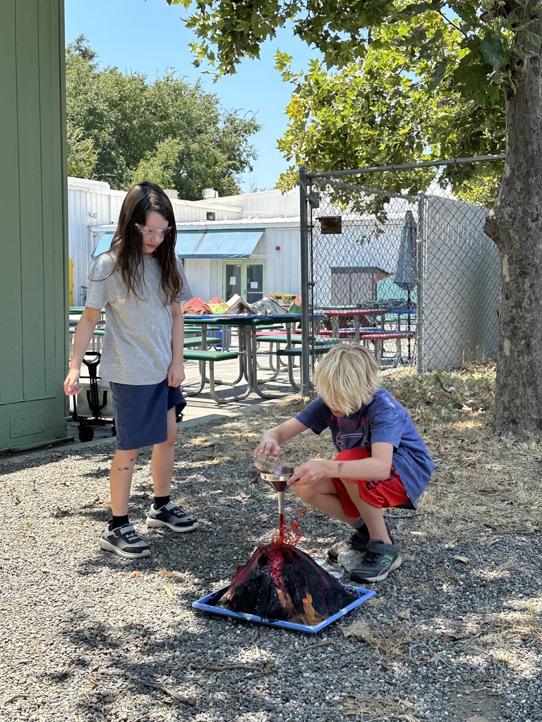 Two students working on a volcano science project!