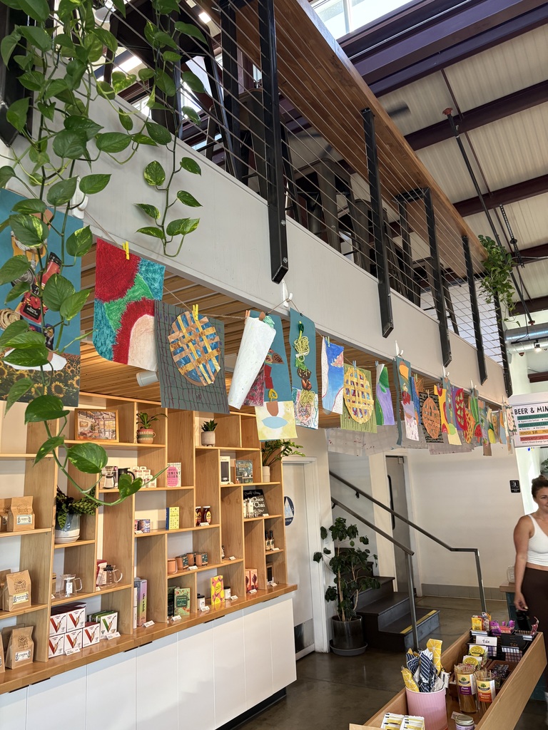 A view of our students' artwork hanging from the balcony inside the cafe!