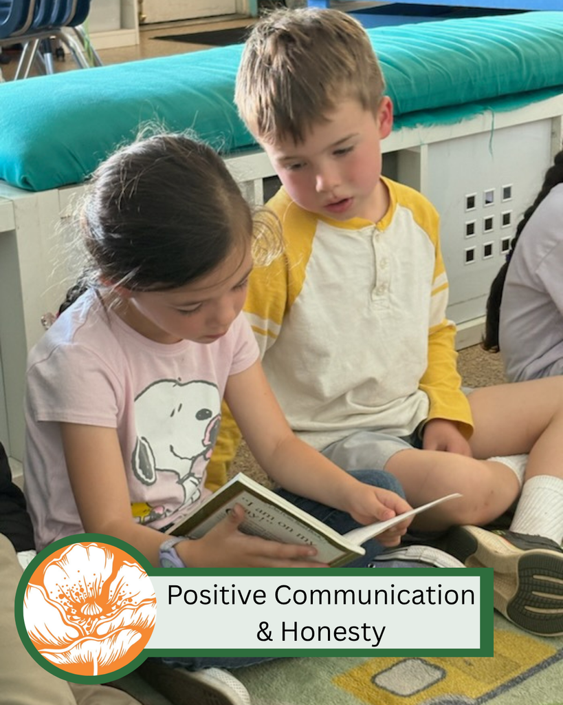 A photo of two students reading from the same book on the carpet together with text that states "Positive Communication & Honesty."