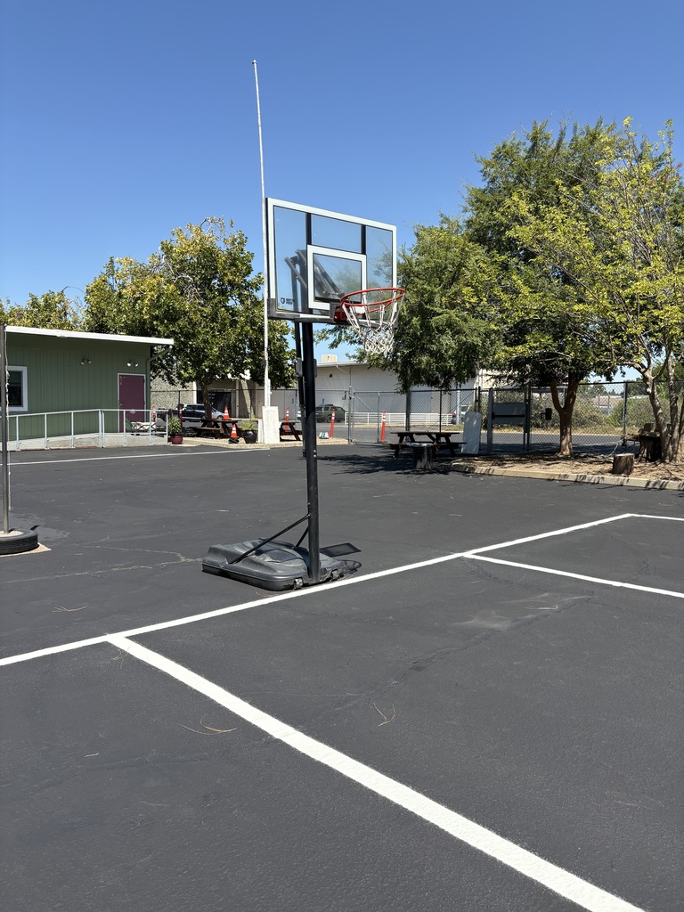 A photo of our newly resealed blacktop with a freshly painted basketball court.
