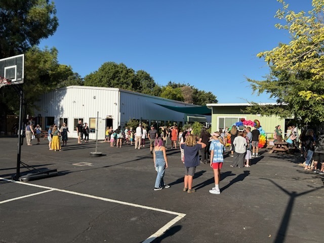 A view of our school blacktop and two of our classrooms as everyone is walking through the gates for the first day of school.