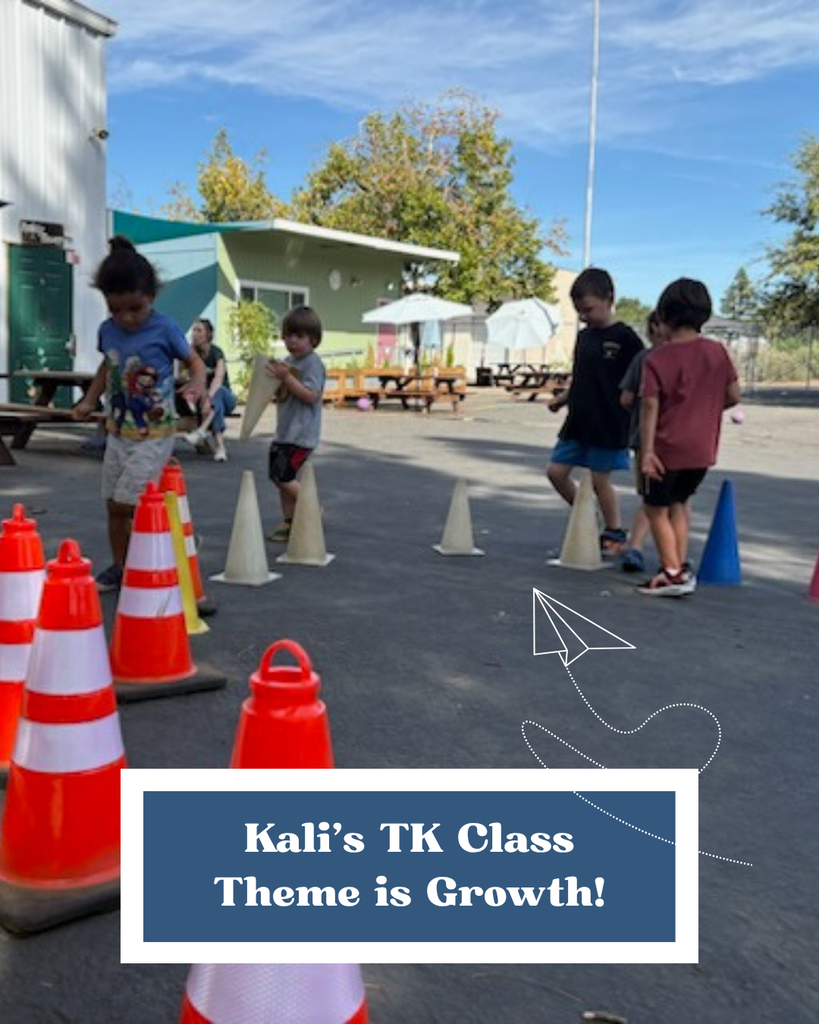 This is a photo of our TK class playing on the blacktop. They have arranged cones in a circle and are running around them and weaving in and out. In a navy blue framed box towards the bottom of the photo is a caption that says "Kali's TK class theme is Growth!