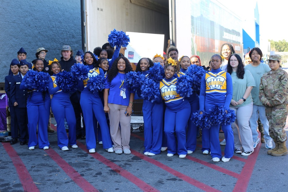 Student volunteers from FBLA, FFA, HOSA, Beta Club, varsity cheer, and JROTC/AFJROTC pose together at the Walmart Supercenter after delivering donations.
