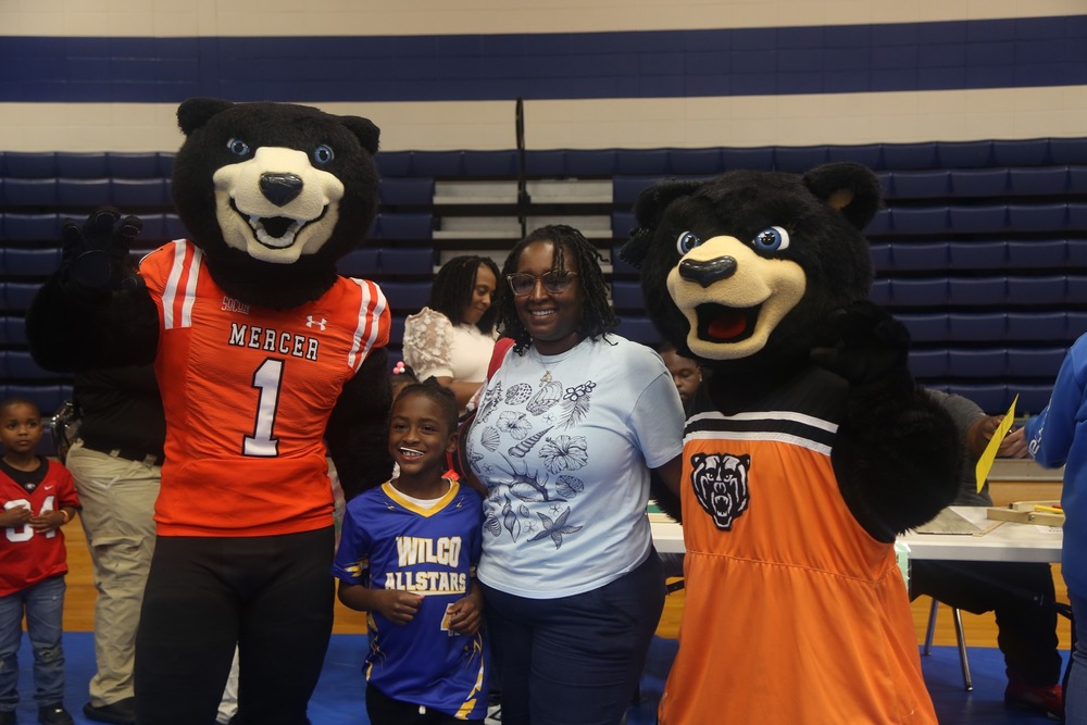 Mercer  school mascot poses and interacts with children during the Title I Meeting and STEM Night.
