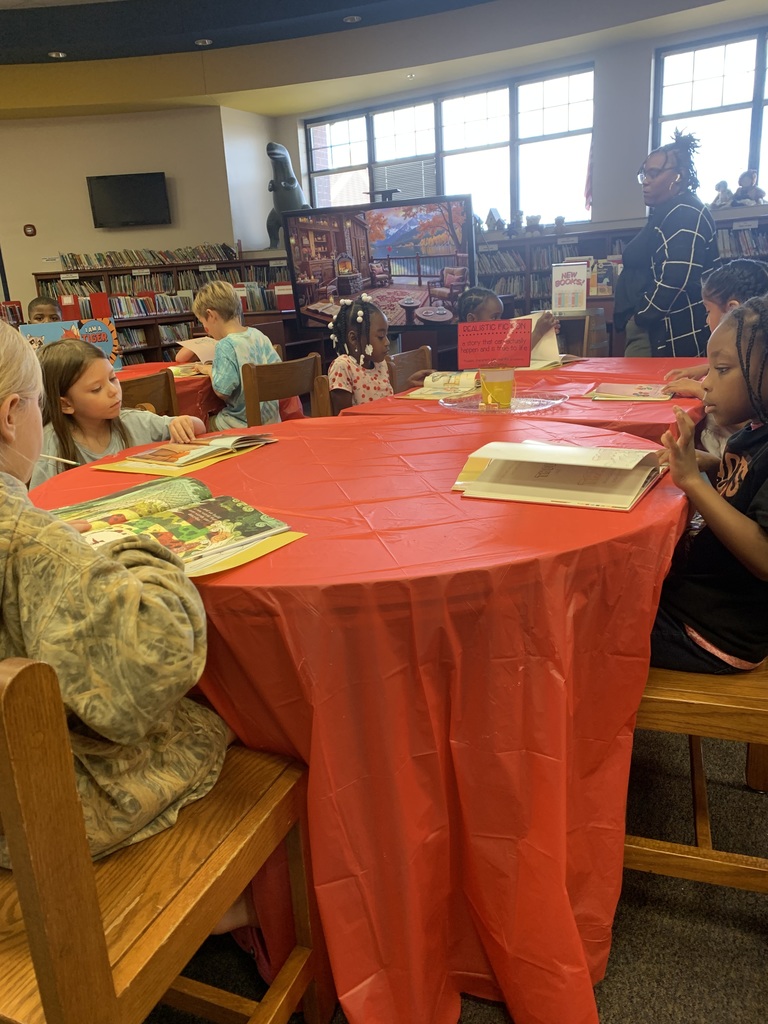Students writing their notes from the book