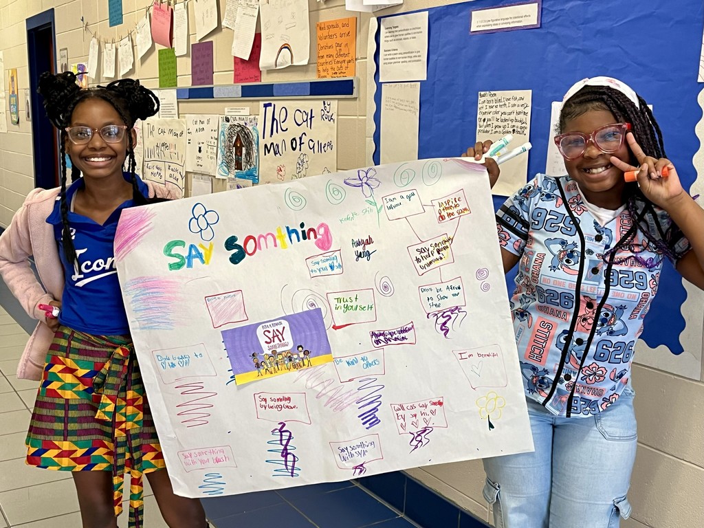 girls showing off their poster