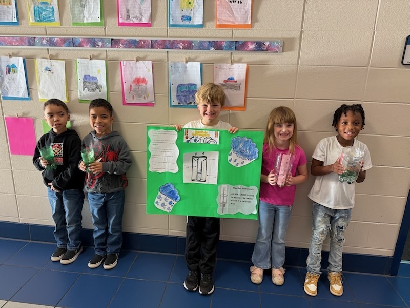 students holding poster