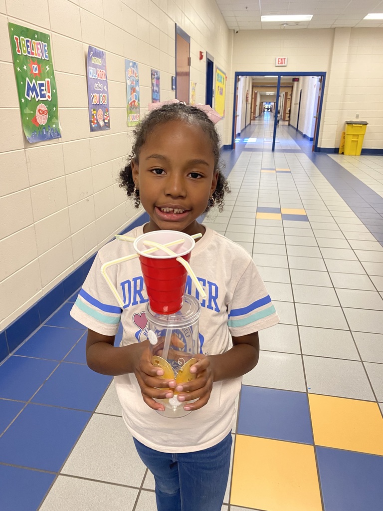 student holding their wind vane