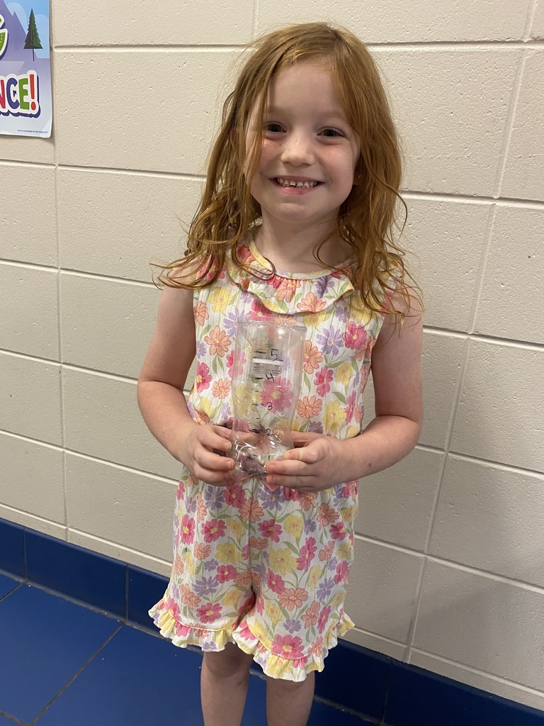 student holding a weather instrument