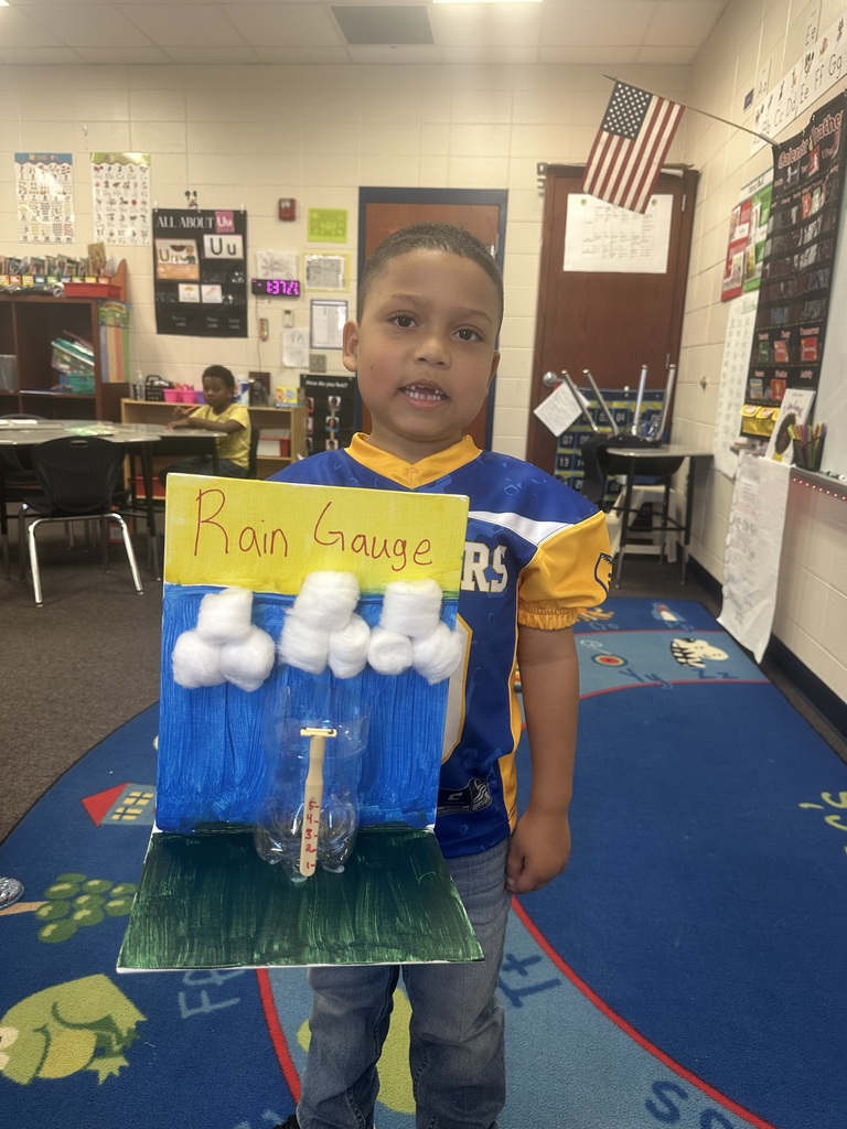 Student holding his rain gauge