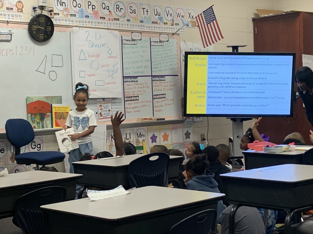 Student pointing to the letters in a book