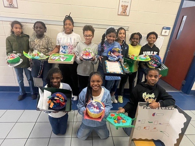 Fifth grade students display plant and animal cell science projects created in Ms. Burke’s class.