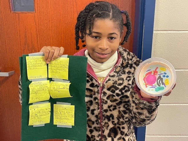 Fifth grade students display plant and animal cell science projects created in Ms. Burke’s class.