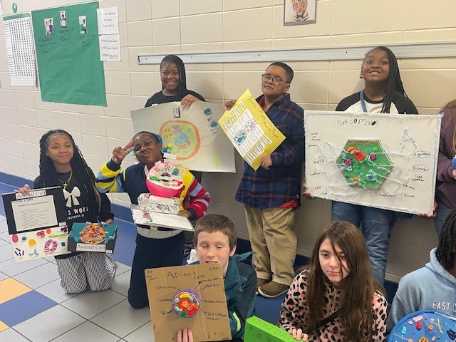 Fifth grade students display plant and animal cell science projects created in Ms. Burke’s class.