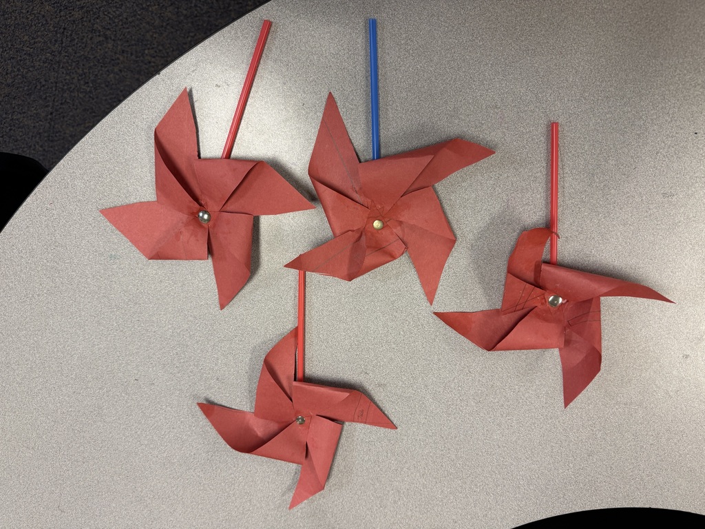 Elementary students in an afterschool program design and test handmade windmills, exploring how wind energy works through a hands-on STEM activity.
