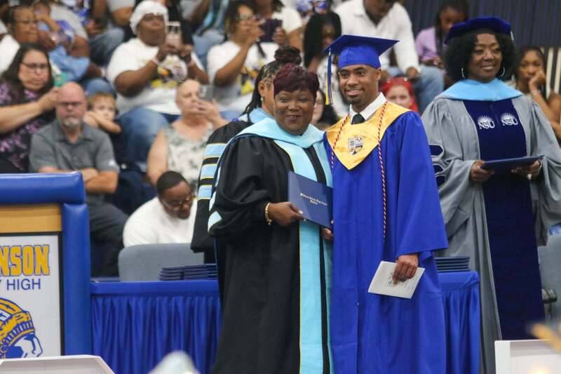 A graduate receives a diploma during the Wilkinson County High School Class of 2026 commencement ceremony.