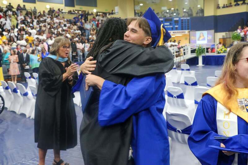 School leaders and faculty congratulate graduates as they complete commencement exercises.