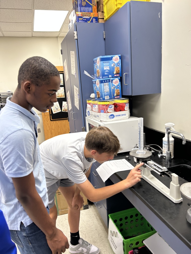 Physical Science students practicing with scientific instruments.