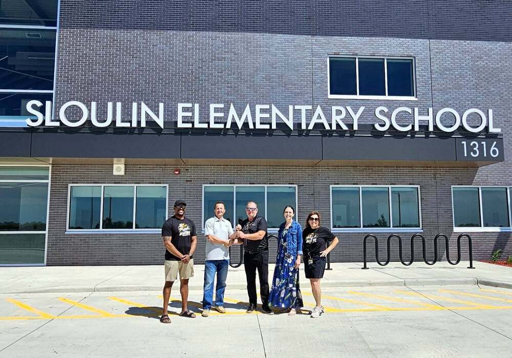 Sloulin Elementary School with people standing in front