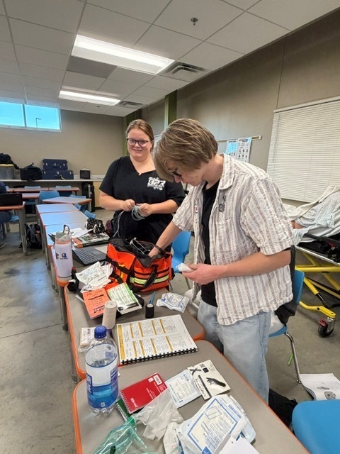 2 students checking EMT bag for inventory