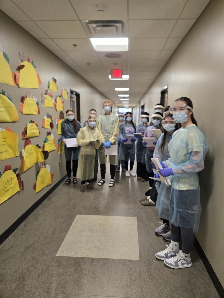 group of students standing in hallway with PPE gear on