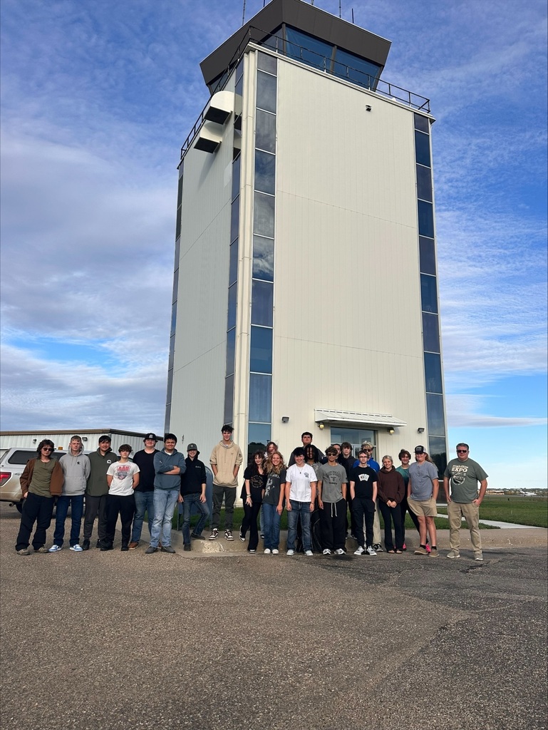 class of students in front of Bismarck Airport tower