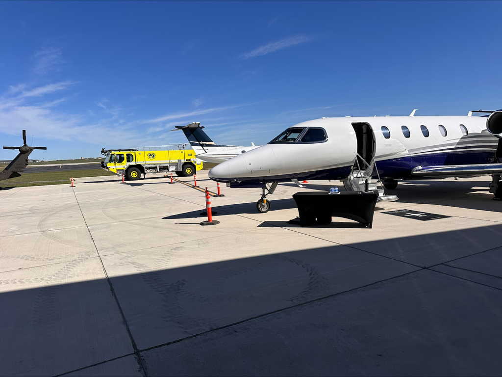 small jet and emergency vehicle parked at Bismarck airport