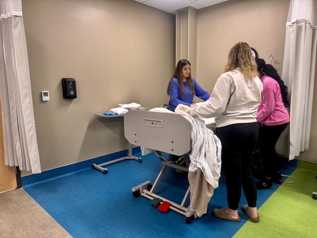 3 students making hospital bed