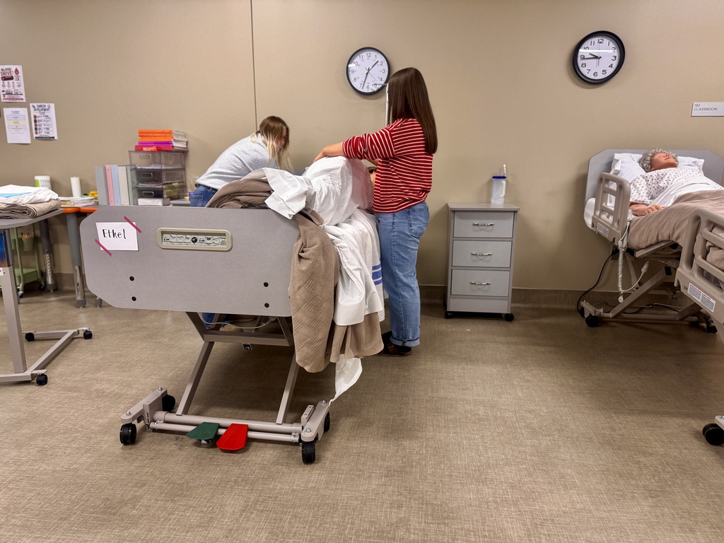 2 students making hospital bed