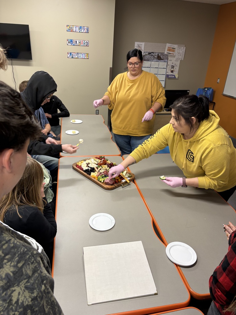 2 instructors with food demonstration and a group of students watching