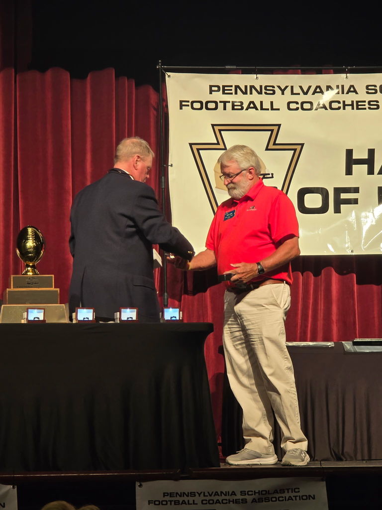 Doug dahms receiving honor and shaking hands