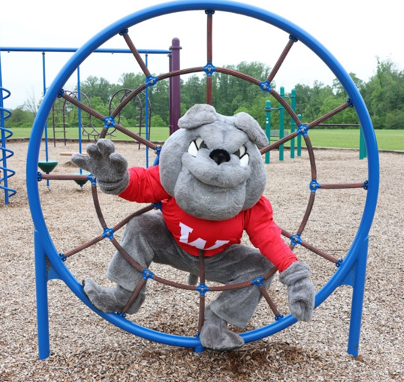 Bulldog mascot playing on playground