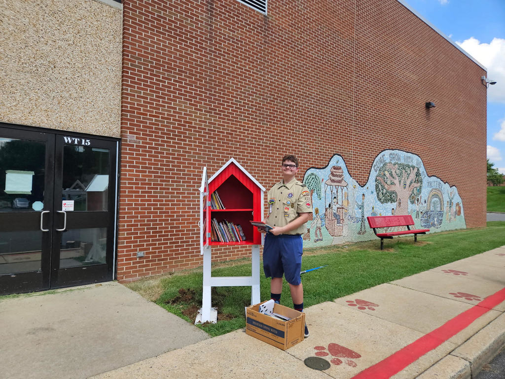 Students with little library placing books inside