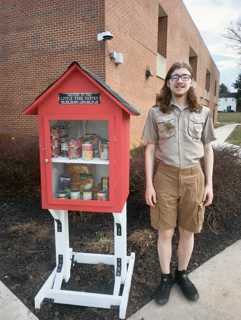 Collin with little freee library in eagle scout uniform
