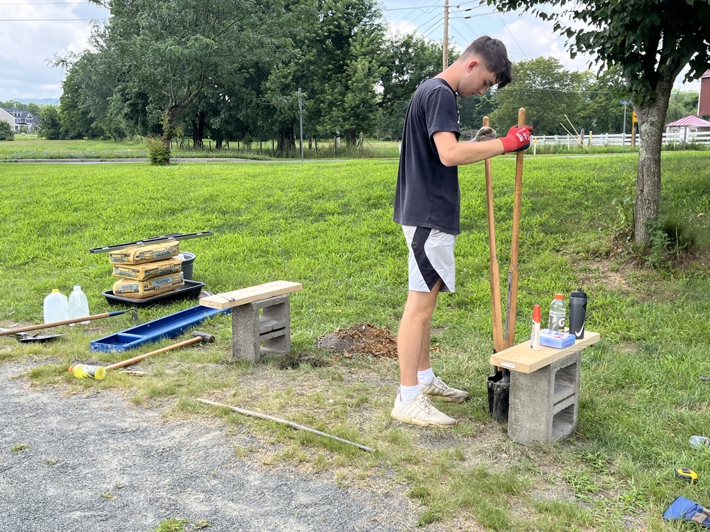 Student working on bench with tools