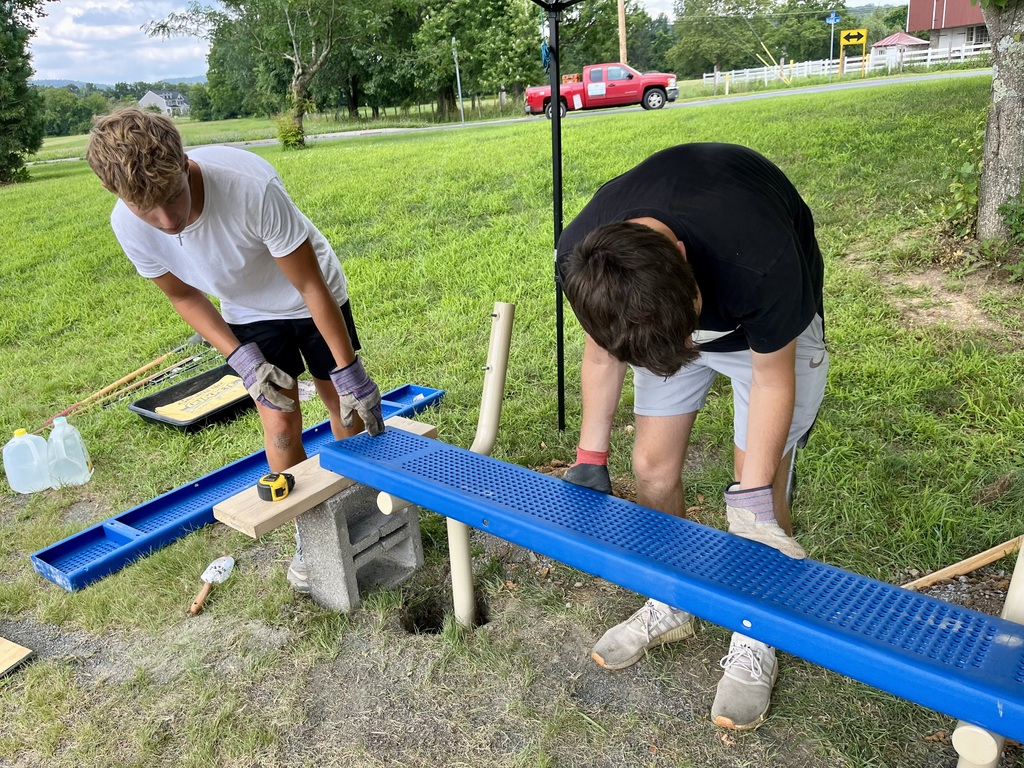 Boys working together to put bench together