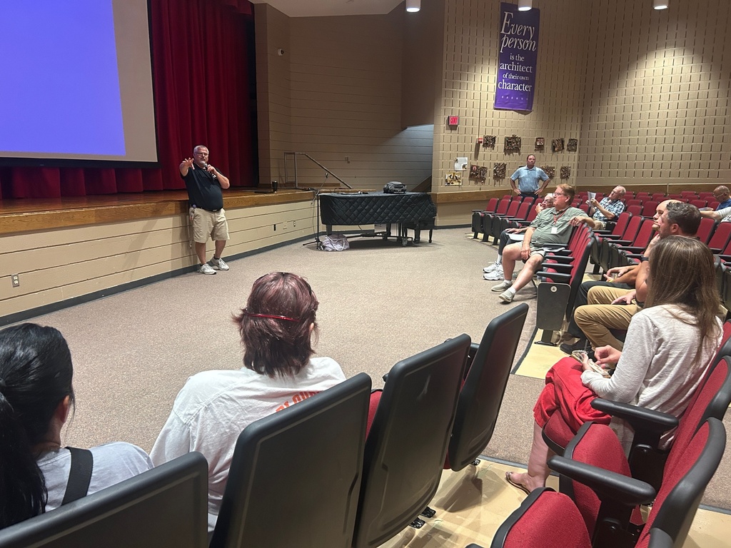 Transportation director talking to transportation department in auditorium 