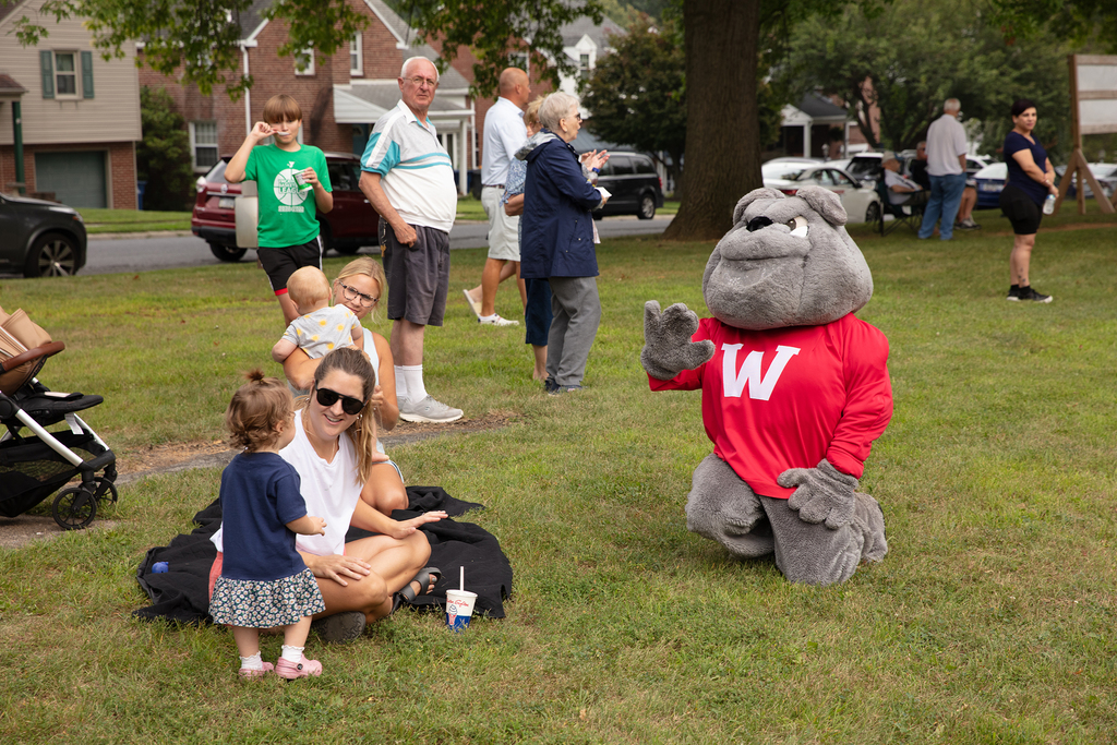 Bulldog mascot playing with kids