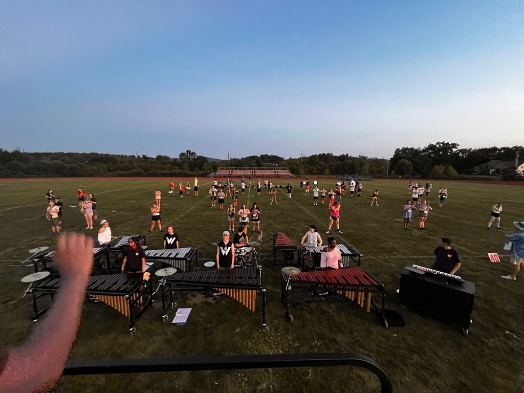 students on field with instruments