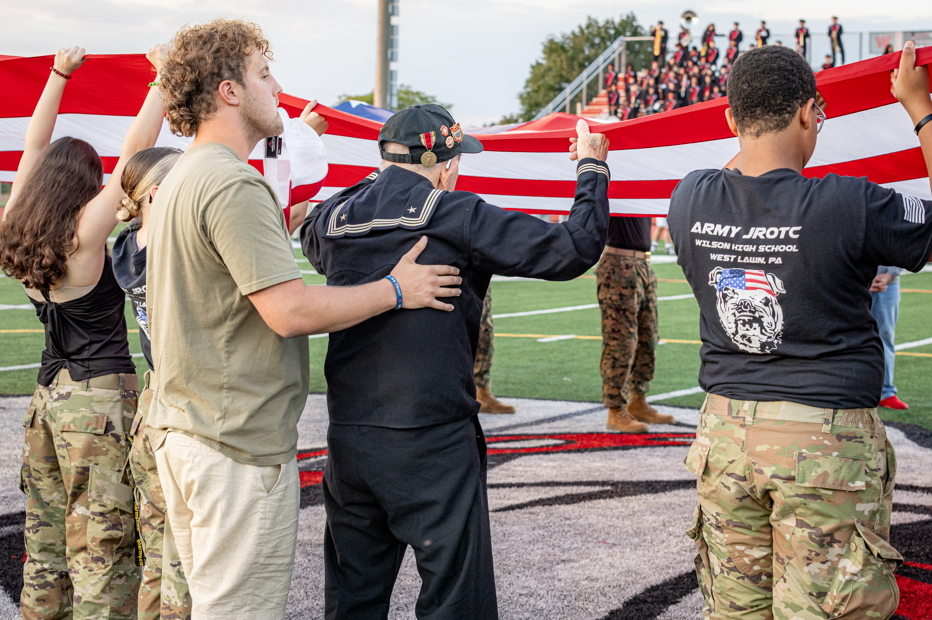 veteran holding flag on the field