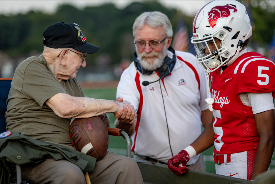 Veteran shaking coach dahms hand