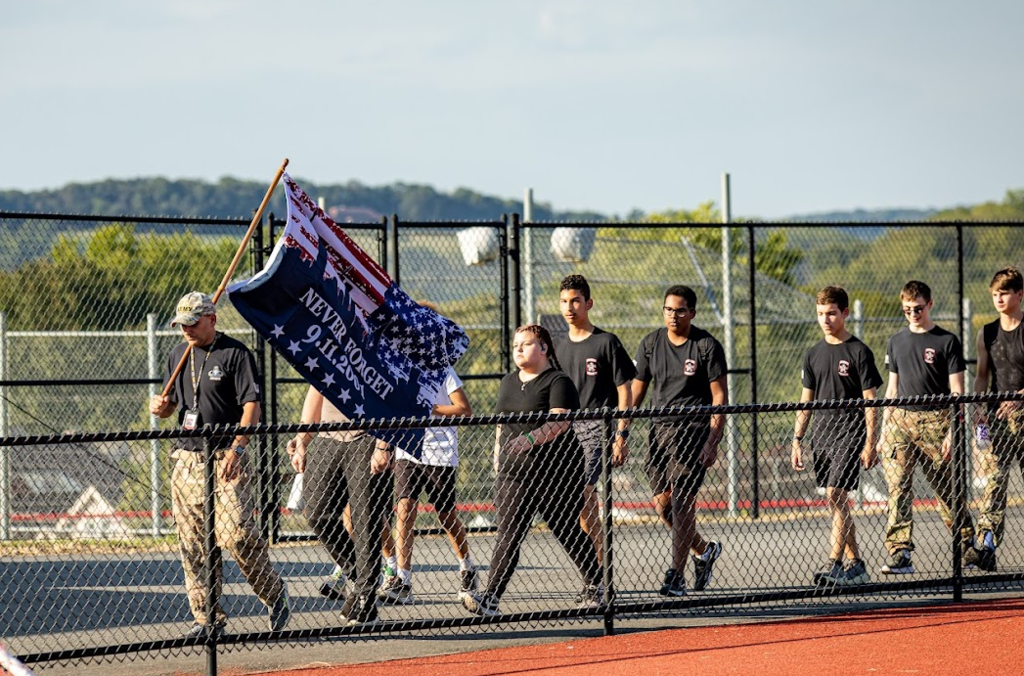 cadets walking with never forget flag