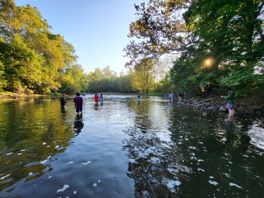 wide shot of students in creek