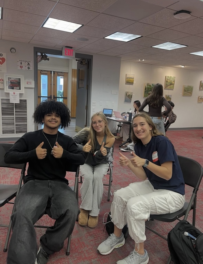 students thumbs up and smiling
